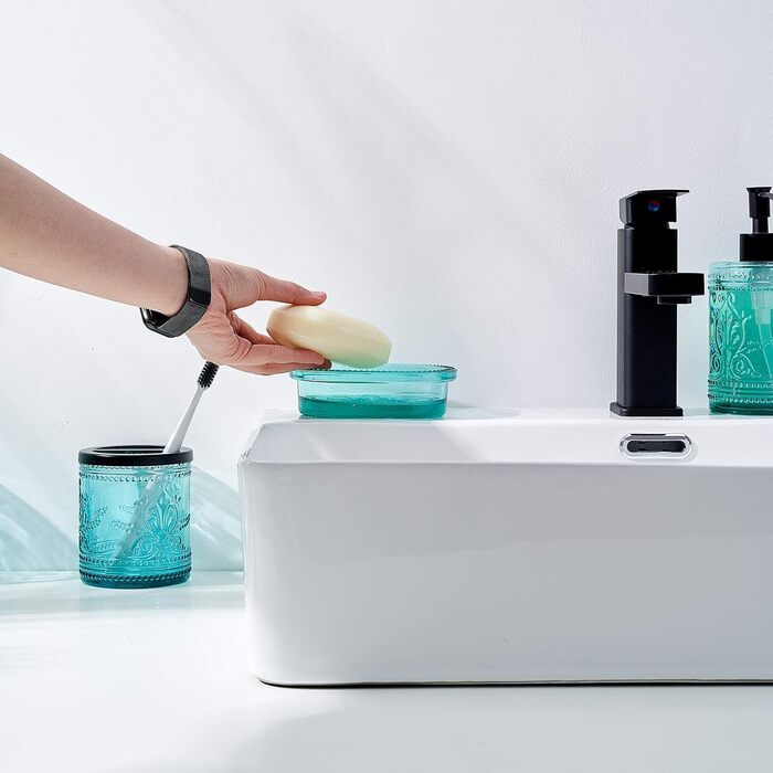 4-piece glass bathroom accessory set with decorative pressed pattern, including soap dispenser, tumbler, soap dish, and toothbrush holder, blue-green