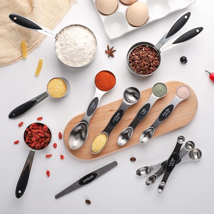 Measuring cup and spoon set includes 5 stainless steel measuring cups, 7 magnetic measuring spoons, and 1 leveler for dry or liquid ingredients (black)