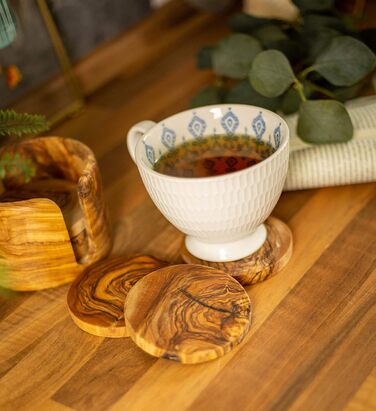 Set of 6 round beer coasters made of olive wood, 8.5 cm in diameter, including storage box. Suitable for glasses, mugs, cups, and vases.