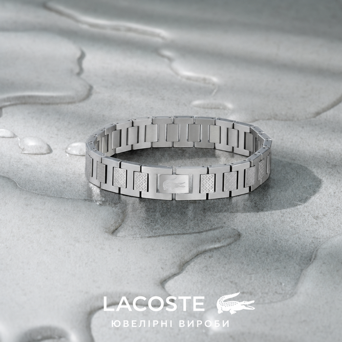 Браслет Lacoste MetroPole з застібкою-кнебелем. З візерунком petit piqué. Нержавіюча сталь, посріблений, для чоловіків та жінок
