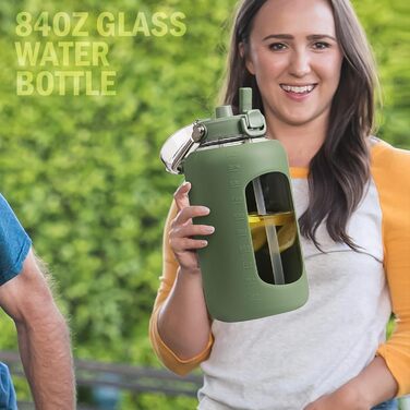 BLUEGO 2500ml Glass Drinking Bottle with Stainless Steel Handle, 2.5L Large Water Bottle with Time Markers and Silicone Sleeve, Half Gallon Water Jug BPA-Free for Sports, Daily Use, Light Green (Olive)
