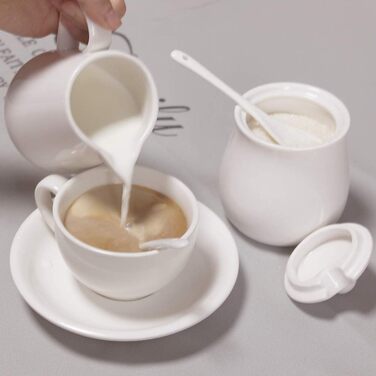 Cream-colored ceramic set for cream and sugar, coffee service, sugar bowl with lid and spoon, cream pitcher, creamer